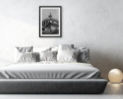 A black and white print of the Basilica of Parma hung in a white bedroom. By Photographer Scott Allen Wilson.