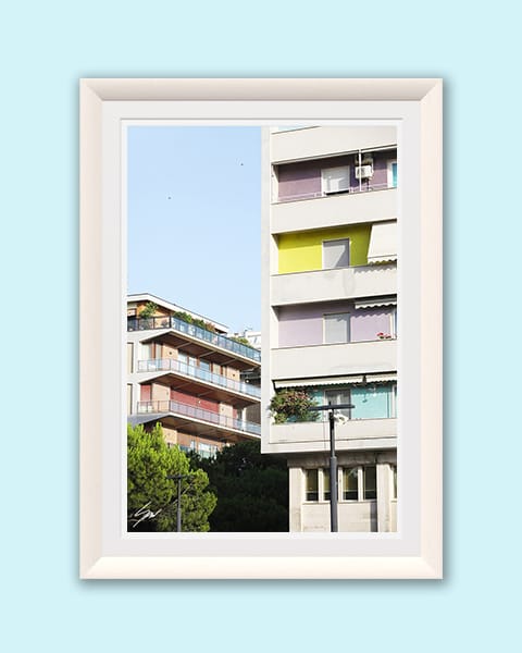 A white framed print of colorful buildings in Pescara, Italy. By Photographer Scott Allen Wilson.