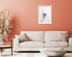A white framed print of a detail of the Ponte Ennio Flaiano in Pescara, Italy hanging in a room with light colored decor. By Photographer Scott Allen Wilson.