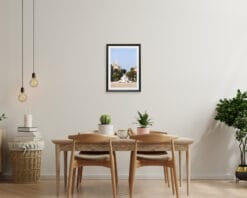 A print of Fontana la Nave in Pescara, Italy, hangs in a cream colored room with wooden furniture. By Photographer Scott Allen Wilson.