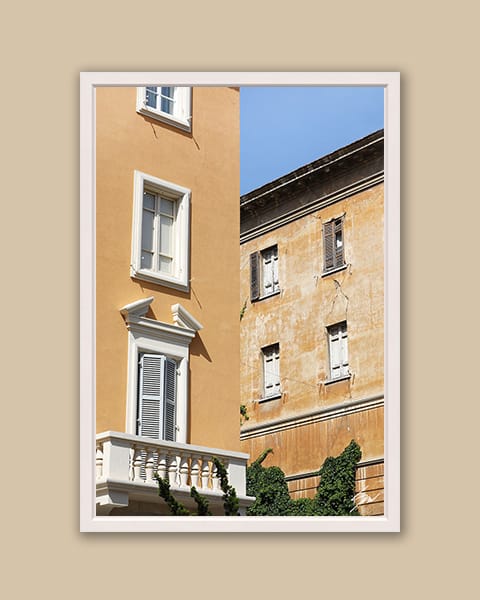 A white framed print of butter-colored buildings in Pescara, Italy. By Photographer Scott Allen Wilson.