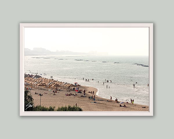 White framed print of a crowded beach in Pescara, Italy. Shot by Photographer Scott Allen Wilson.