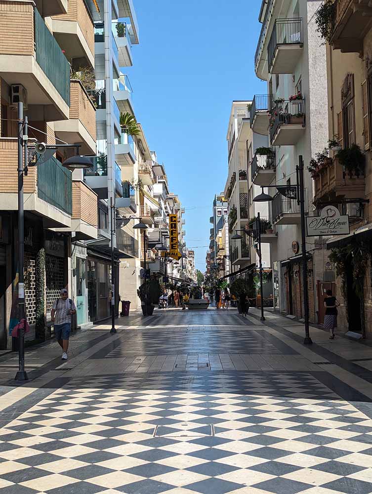 A photo of the black and white checkered paved way of Via Firenze, in Pescara, Italy
