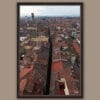 A dark brown framed print of red tiled rooftops in the city of Lucca, Italy, with some bell towers visible. By Photographer Scott Allen Wilson.