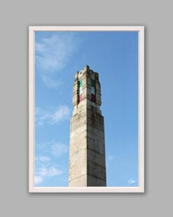 A white framed print of a monument in Lucca, Italy, displaying the colors of the Italian flag: green, white and red. By Photographer Scott Allen Wilson.