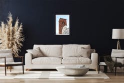 A white framed print of the San Francesco Church in Lucca, Italy, hanging in a classy living room. By Photographer Scott Allen Wilson.