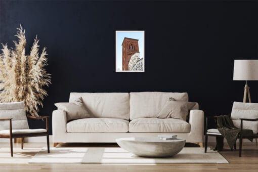 A white framed print of the San Francesco Church in Lucca, Italy, hanging in a classy living room. By Photographer Scott Allen Wilson.