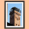 A black framed print of Torre Guinigi with trees on top of it in the city of Lucca, Italy. By Photographer Scott Allen Wilson.