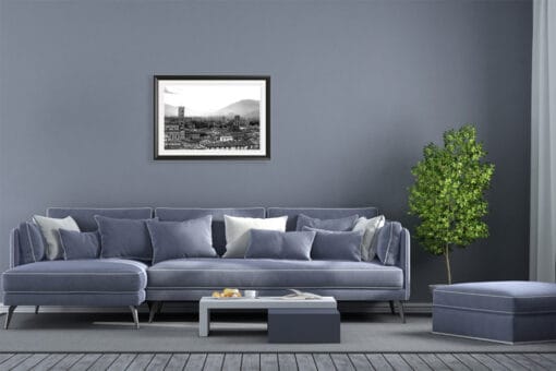 A black framed b&w print of Lucca, Italy, hanging in a grey toned living room. By Photographer Scott Allen Wilson.