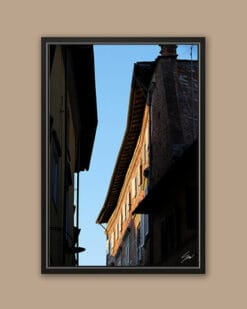 A black framed print of buildings in the city of Lucca, Italy. By Photographer Scott Allen Wilson.