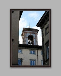 A dark brown framed print of a bell tower in the city of Lucca, Italy. By Photographer Scott Allen Wilson.