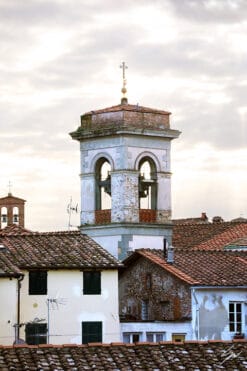 A bell tower and red tiled rooftops in the city of Lucca, Italy. By Photographer Scott Allen Wilson.
