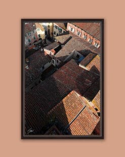 A dark brown framed print of red tiled rooftops in the city of Lucca, Italy. By Photographer Scott Allen Wilson.