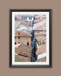 A black framed print of a view of the city of Lucca, Italy, from above. By Photographer Scott Allen Wilson.