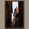 A dark brown framed print of rooftops in Lucca, Italy. By Photographer Scott Allen Wilson.