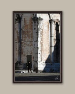 A dark brown framed print of a view of the city of Lucca where an old man is taking a stroll, Italy. By Photographer Scott Allen Wilson.