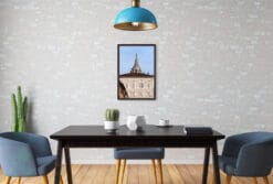 A framed print of the Royal Palace of Torino, Italy, hanging in a modern style kitchen.