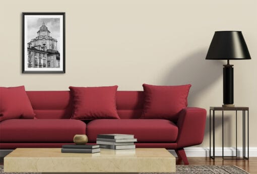 A framed print of the San Lorenzo Church in Torino, Italy, hanging in a modern living room.