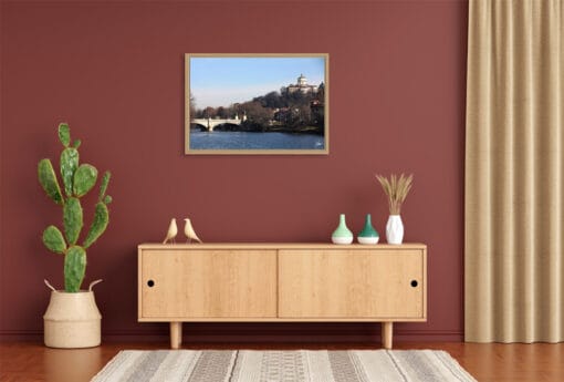 A wooden framed print of the banks of the river Po in Torino, Italy, hanging in a modern living room with wooden decor. By Photographer Scott Allen Wilson.