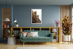 A white framed print of power lines in Torino, Italy, hanging in an hectic living room. By Photographer Scott Allen Wilson.