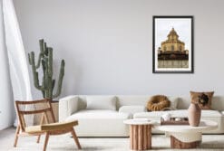 A black framed print of the Royal Church of San Lorenzo in Torino, Italy, hanging in a minimal living room with wooden decor. By Photographer Scott Allen Wilson.