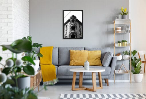 A b&w framed print of a noble building in Torino, Italy, hanging in a modern living room with wooden decor. By Photographer Scott Allen Wilson.