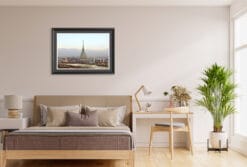 A black framed print of the skyline of Torino, Italy, hanging in a living room with wooden decor. By Photographer Scott Allen Wilson.