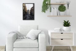 A black framed print of the tram railway system in Torino, Italy, hanging in a minimal living room. By Photographer Scott Allen Wilson.