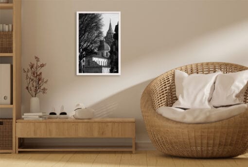 A white framed print of the Holy Shroud Chapel in Torino, Italy, hanging in a minimal living room with wooden decor. By Photographer Scott Allen Wilson.