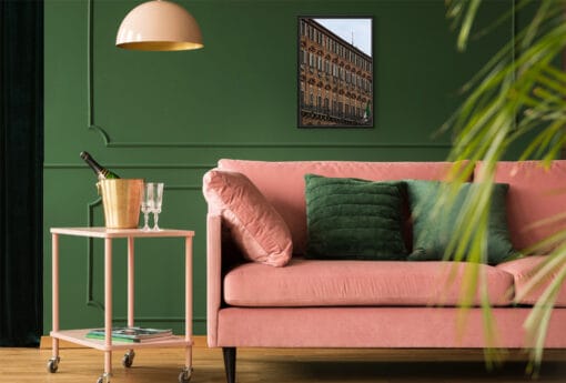 A black framed print of the Government Palace in Torino, Italy, hanging in a boho living room. By Photographer Scott Allen Wilson.