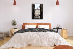 A black framed print of the town hall of Torino, Italy, hanging in a modern bedroom. By Photographer Scott Allen Wilson.