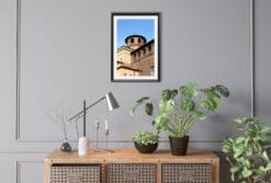 A black framed print of Palazzo Madama in Torino, Italy, hanging in an office with wooden decor. By Photographer Scott Allen Wilson.