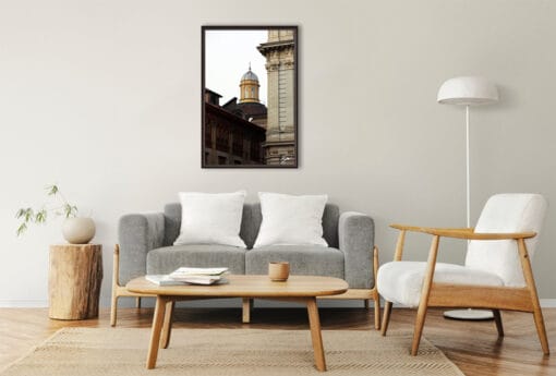 An ebony framed print of a church dome in Torino, Italy, hanging in a modern living room with wooden decor. By Photographer Scott Allen Wilson.