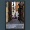 A black framed print of a cobblestone street in Torino, Italy. By Photographer Scott Allen Wilson.