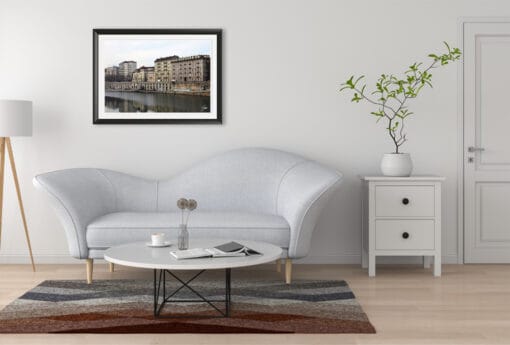 A black framed print of the banks of the river Po in Torino, Italy, hanging in a minimal living room. By Photographer Scott Allen Wilson.