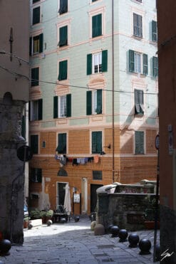 A downhill cobblestone alley meets the bright colors of an elegant Genovese residential block. Photo captured by Travel Photographer Scott Allen Wilson.