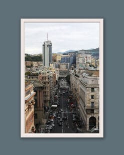 White framed artistic print of a busy road in Genova crowded with vehicles and surrounded by urban structures. Photo captured by Travel Photographer Scott Allen Wilson.