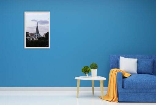 Soft clouds reflect their purple lights over the whole scene, making the blue decor of this living room a perfect match for it.