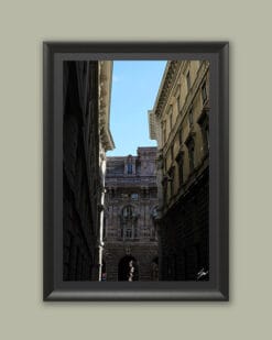 Wooden framed artwork by Travel Photographer Scott Allen Wilson, showcasing three historical buildings facing each other under a serene sky.