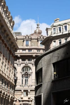 Neutral toned historical facades shine bright under the Genovese sky, in perfect contrast with the dark stone walls of a contemporary arched construction. Photo captured by Travel Photographer Scott Allen Wilson.