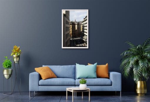 Scott Allen Wilson’s beautifully framed work of art showcasing Genova’s contrast between sunlight and its city streets, perfectly displayed in a blue modernly designed room.