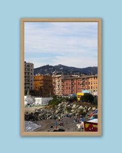 Wooden framed artistic print of a lovely scenery in Genova, Italy, showcasing a rocky beach under colorful houses. Photo captured by Travel Photographer Scott Allen Wilson.