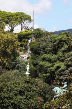 Two statues rise in the woods of Genova, Italy. Photo captured by Travel Photographer Scott Allen Wilson.