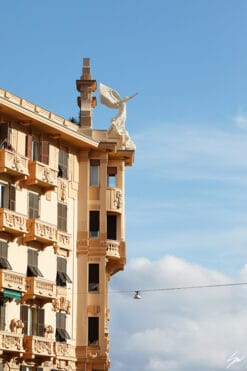 The white statue of an angel posing on top of a gorgeous edifice. Photo captured by Travel Photographer Scott Allen Wilson.