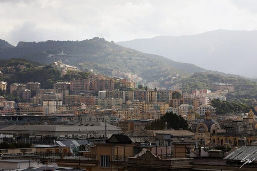 Colorful homes flow down hillsides, blending with the lush green landscape of Genova. Photo captured by Travel Photographer Scott Allen Wilson.