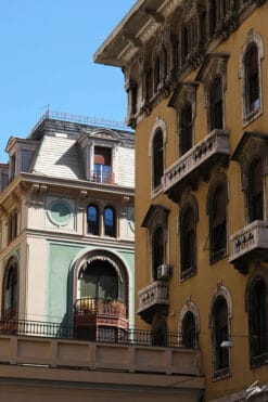 The bright and shaded facades of some historic residential buildings in Genova, Italy. Photo captured by Travel Photographer Scott Allen Wilson.