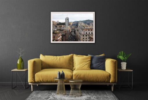 The multiple pastel colored elements in the image blend with the decorations of this modern living room. The dark grey walls and flooring match with the streets below, while the mustard yellow couch adds a touch of color to the environment.