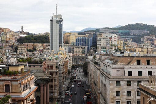 A scene where modern and historic architecture meet, above the vitality of the city streets in Genova, Italy. Photo captured by Travel Photographer Scott Allen Wilson.