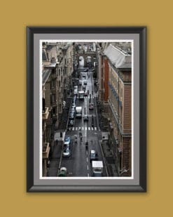 Wooden framed artistic print of a detailed urban scenery in Genova, Italy, featuring a bustling street enclosed by tall and elegant buildings. Photo captured by Travel Photographer Scott Allen Wilson.