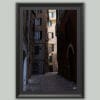 Wooden framed artistic print of a historical city alley, winding across imposing structures. Photo captured in Genova, Italy, by Travel Photographer Scott Allen Wilson.